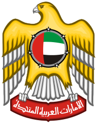 The image shows the emblem of the United Arab Emirates, reminiscent of a Miami Beach sunset. It features a golden falcon with wings spread wide, clutching a red banner with Arabic script. A circular shield with the UAE flag is on its chest, detailed with black-and-white accents. Miami Beach Notary