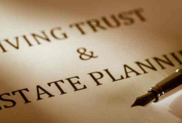 Close-up of a legal document titled "Living Trust & Estate Planning" in bold letters. A fountain pen with a metallic nib lies angled on the lower right corner, ready for signatures from a Miami Beach notary. The softly lit image exudes warmth, highlighting the text and pen.